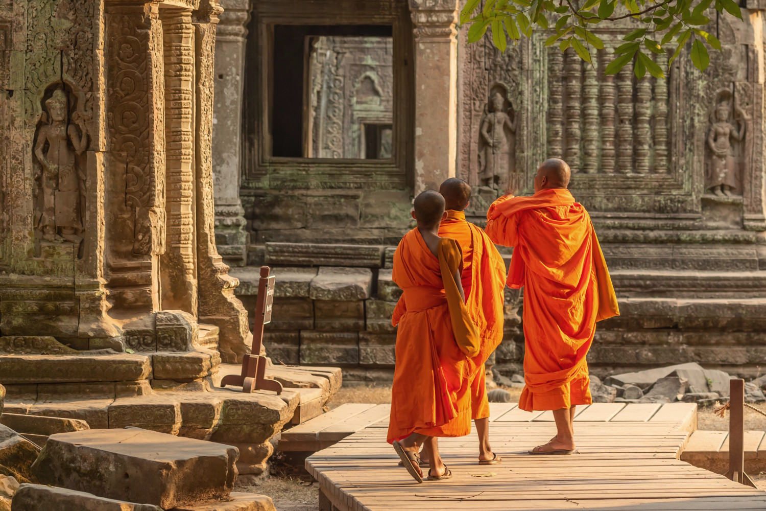 three,monks,walking,through,the,buddhist,temple,of,ta,prohm