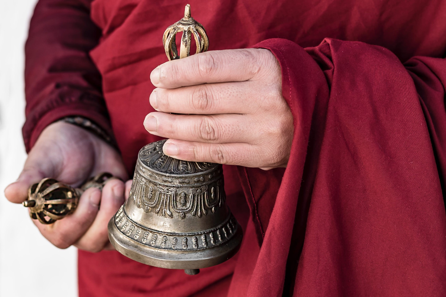 amankora, bhutan accommodation, thimphu lodge, monk with dorji (thunderbolt) and drilbu (bell) during chorten courtyard sungkey blessing