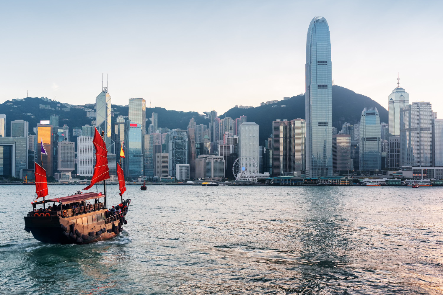 tourist,sailboat,crosses,victoria,harbor,from,kowloon,side,to,the